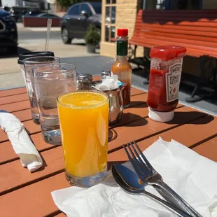 a glass of orange juice on a table