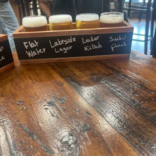 ows beer glasses in a wooden tray