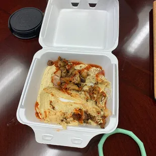 a pizza in a styrofoam container
