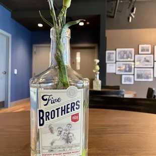 a glass bottle with flowers in it