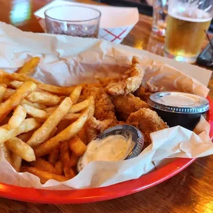a basket of fried fish and fries
