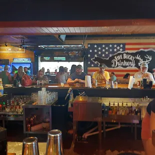 a group of people sitting at a bar