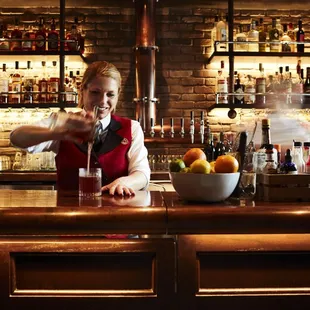 Bartender whipping up something tasty at Cooper's bar