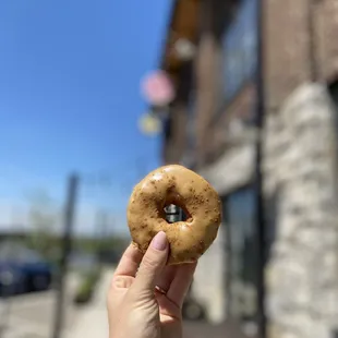 a hand holding a doughnut