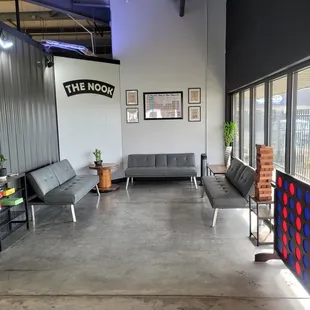 a couch, chairs, tables, and television