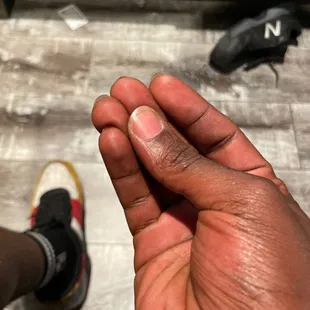 a hand holding a small piece of food