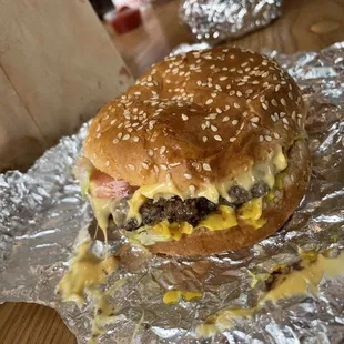 a cheeseburger on aluminum foil