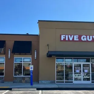 Exterior photograph of the Five Guys restaurant at 2600 Southwest Barton Street in Seattle, Washington.