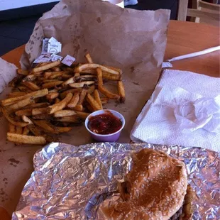 a burger and french fries on a table