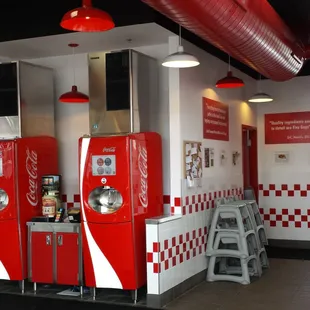 a row of coca cola vending machines