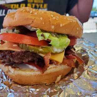 a hamburger with lettuce, tomato, and cheese