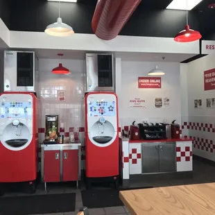 a red and white soda machine in a restaurant