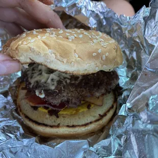 a hamburger wrapped in aluminum foil