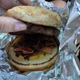 a hamburger with bacon and cheese