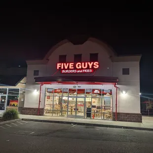 Front of the building at night.