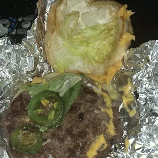 a hamburger with lettuce and cheese