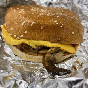 a hamburger with cheese and mushrooms