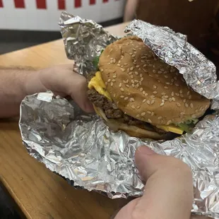 a hamburger wrapped in aluminum foil