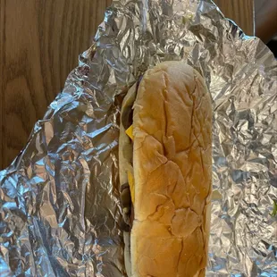 a hot dog wrapped in aluminum foil