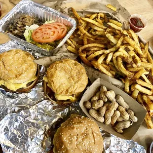 a table full of burgers and fries