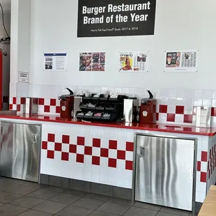 a restaurant counter with red and white checkered tiles