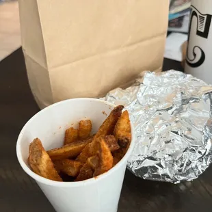 a cup of fries and a paper bag