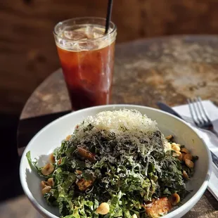 a bowl of salad and a drink