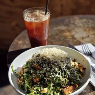 a bowl of salad and a drink