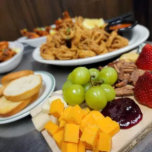 a variety of cheeses, fruit, and crackers