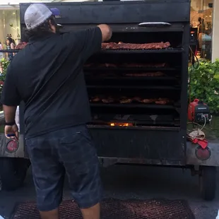 a man standing in front of a grill