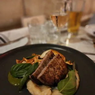 Petition filet mignon over parsnip puree, king trumpet mushroom and chermoula sauce with crispy parsnips.