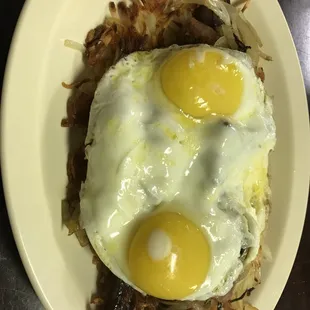 two eggs on top of hash browns