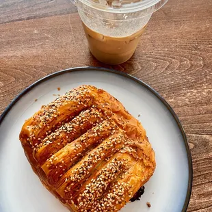 a plate with a pastry and a cup of coffee