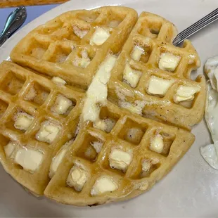 a waffle with butter and eggs