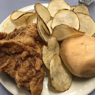 Fried chicken and home fries with a roll
