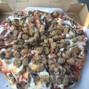 Sausage and mushroom pizza to go. No shortage of toppings here!