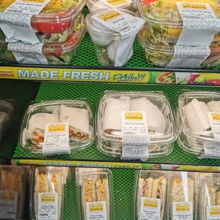 a display of sandwiches and salads