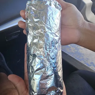 Steak breakfast burrito takes two hands to hold