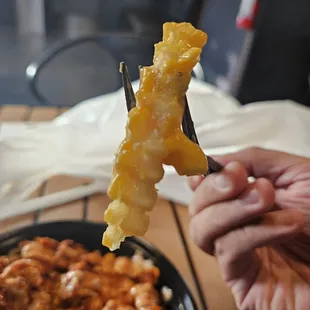 Despite being buried under all that hot sauce and melted cheese, the fries were still very crunchy.  Very good.