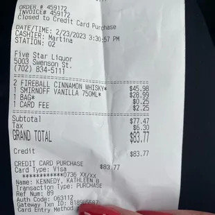 a woman's hand holding a receipt
