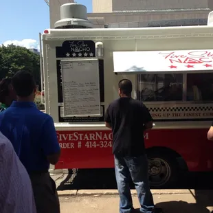 a man standing in front of a food truck