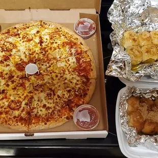 Pepperoni pineapple pizza with extra cheese. Garlic rolls (Top right) Cinnamon rolls (Bottom right)