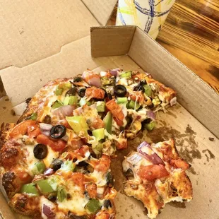 a half eaten pizza in a box