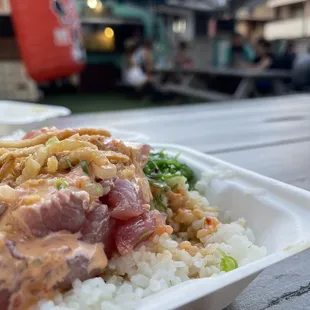 a plate of rice, meat, and vegetables