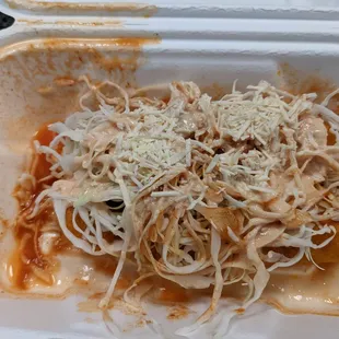 Honduren chicken tacos - two fried chicken tacos topped with a tomato sauce, coleslaw-style cabbage, and cheese