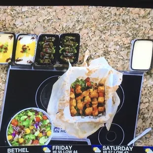 Salad, chicken kabobs, grape leaves , humus and more