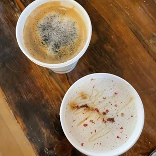 two cups of coffee on a wooden table