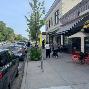 people walking down the sidewalk