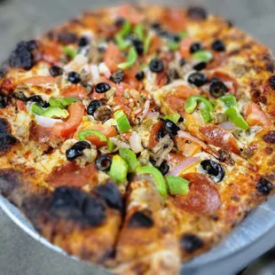 a pizza with black olives and pepperoni