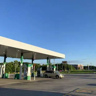 a gas station with a car parked in front of it